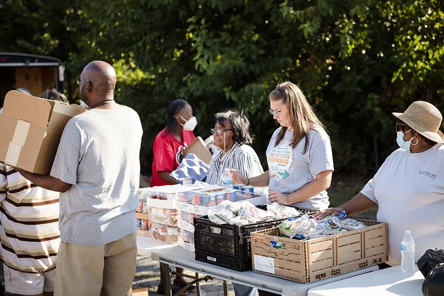 Volunteers distributing food and supplies to neighbors at a Lynn Community Impact event